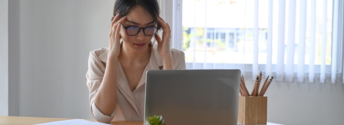 Fatigued businesswoman feeling stressful and depressed from her work.