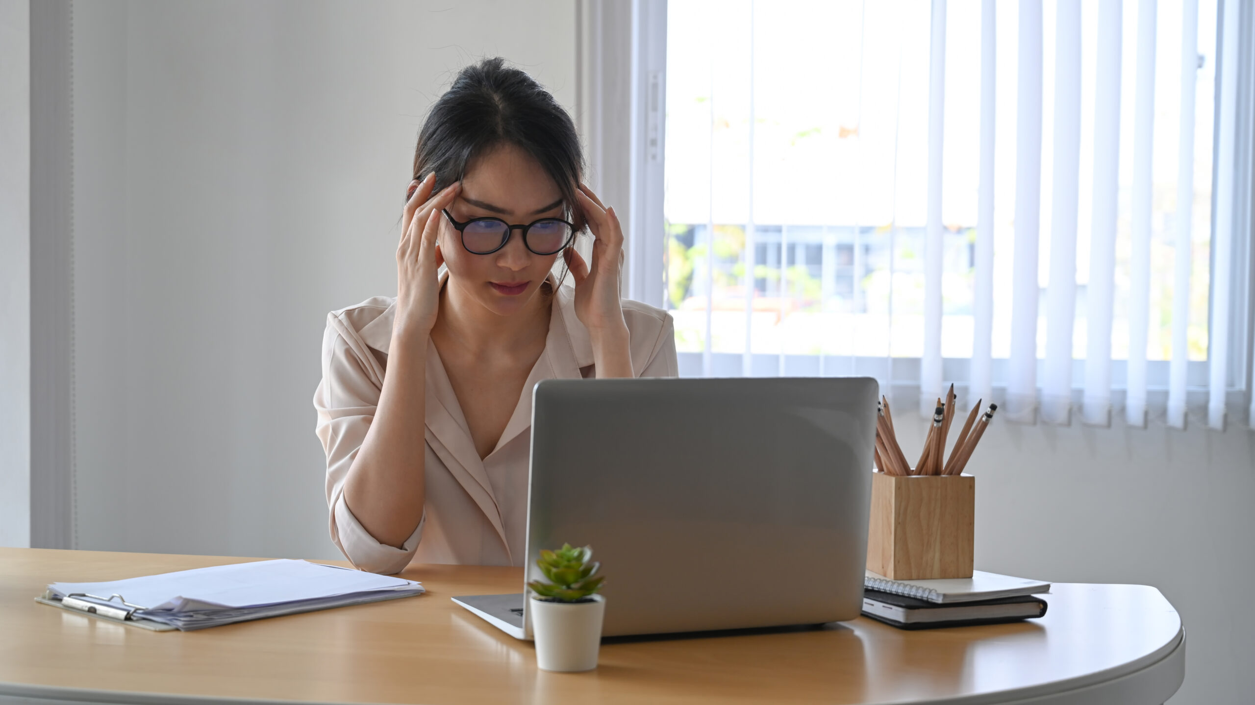 Fatigued businesswoman feeling stressful and depressed from her work.